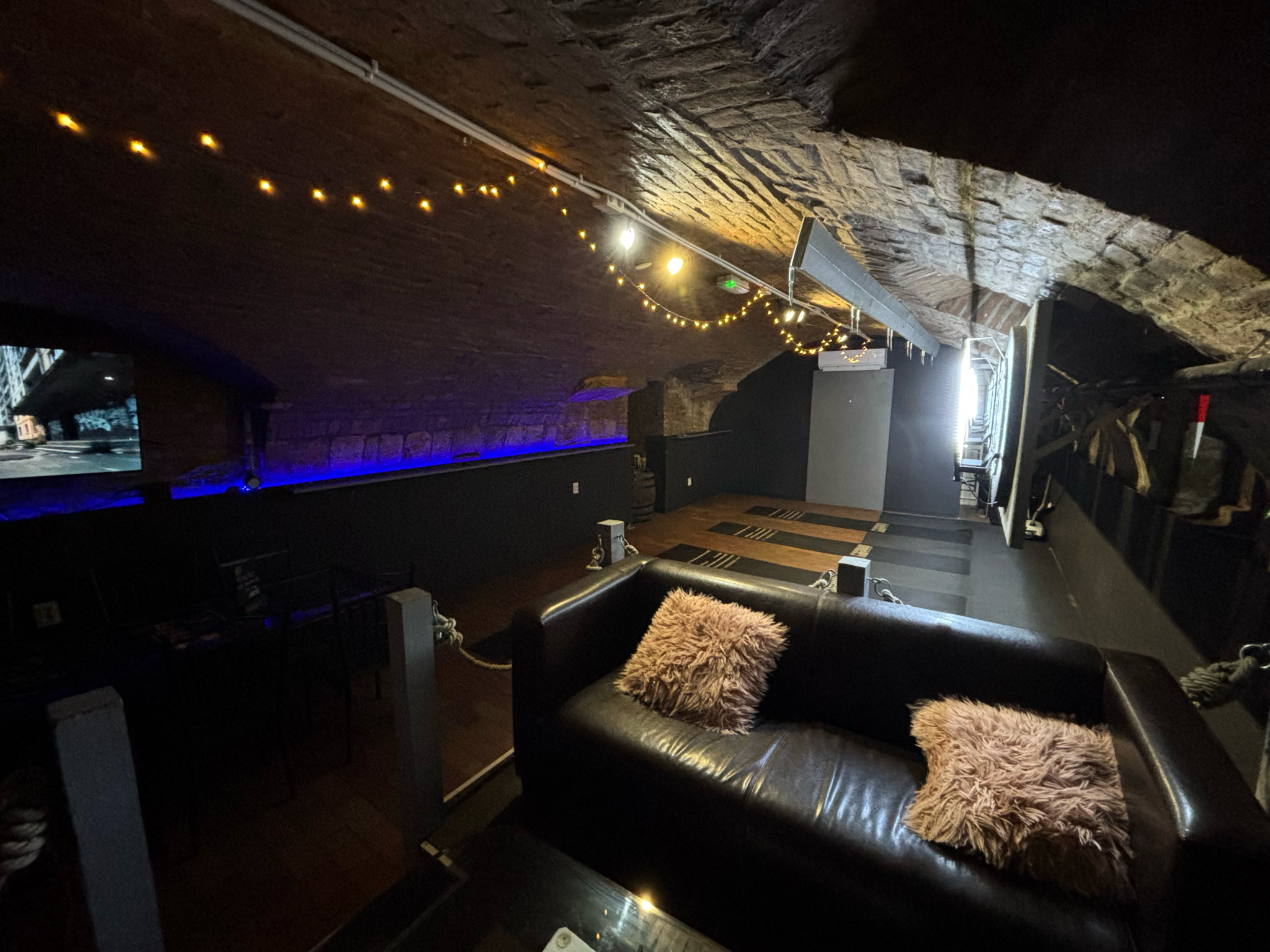 Five professional steel dart lanes in the cozy, arched interior of The Black Door Darts & Sport Bar in downtown Budapest.