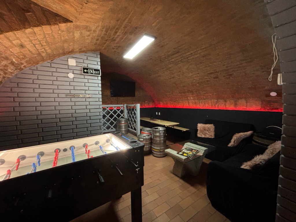 Foosball table and a comfortable lounge area for sports broadcasts and friendly gatherings at The Black Door Darts & Sport Bar.